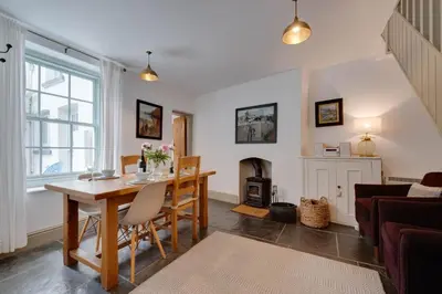 a living room with a table and a fireplace at 2 Bed in Polruan oc-p00697 in Fowey