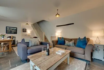 a living room with two couches and a table at 2 Bed in Polruan oc-p00697 in Fowey