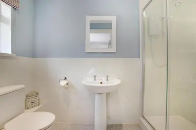 a bathroom with a sink and a toilet and a shower at 5 Bed in Mevagissey oc-p00699 in Mevagissey