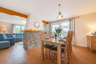 a dining room and living room with a table at 3 Bed in St. Merryn oc-p00700 in St Merryn