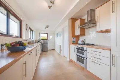 a kitchen with white cabinets and a bowl of fruit on the counter at 3 Bed in St. Merryn oc-p00700 in St Merryn