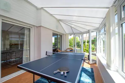 a ping pong table in a room with windows at 3 Bed in St. Merryn oc-p00700 in St Merryn