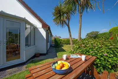 a bowl of fruit sitting on a wooden table at 3 Bed in St. Merryn oc-p00700 in St Merryn