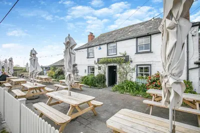 a group of picnic tables in front of a building at 3 Bed in St. Merryn oc-p00700 in St Merryn
