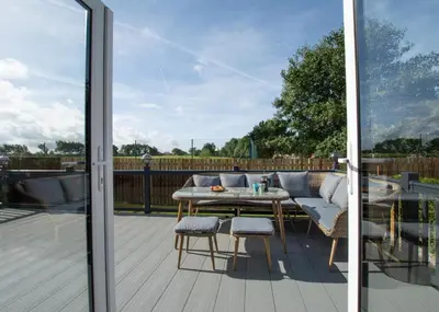a patio with a table and chairs on a deck at 3 Bed in St. Merryn oc-p00701 in St Merryn