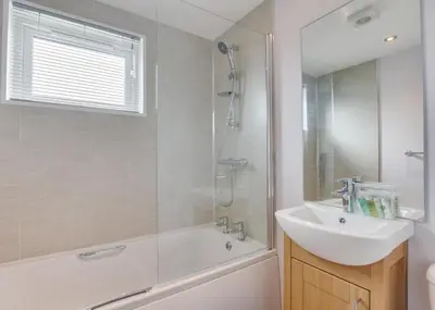 a bathroom with a tub and a sink and a shower at 3 Bed in St. Merryn oc-p00701 in St Merryn
