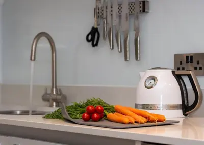 a cutting board with carrots and other vegetables on a kitchen counter at 2 Bed in Fowey oc-p00703 in Fowey