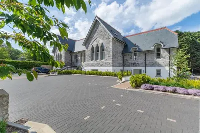 a large stone church with a large parking lot at 2 Bed in Fowey oc-p00703 in Fowey