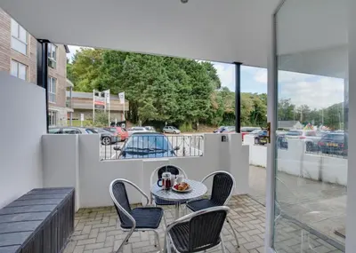 a patio with a table and chairs on a balcony at 2 Bed in Fowey oc-p00708 in Fowey
