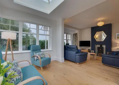 a living room with blue chairs and a tv at 4 Bed in Newquay oc-p00709 in Newquay