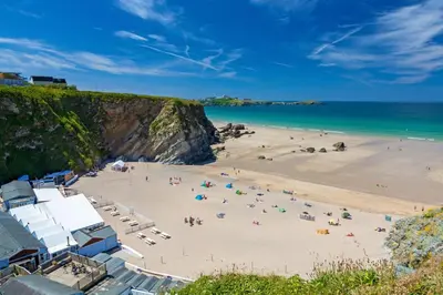 a group of people on a beach near the ocean at 4 Bed in Newquay oc-p00709 in Newquay