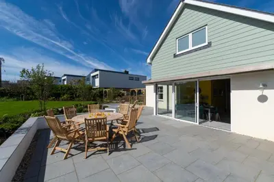 a patio with a table and chairs on it at 4 Bed in Newquay oc-p00709 in Newquay