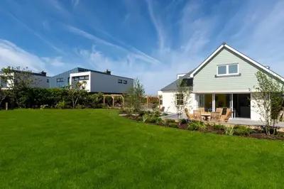 a house with a lawn and a building at 4 Bed in Newquay oc-p00709 in Newquay
