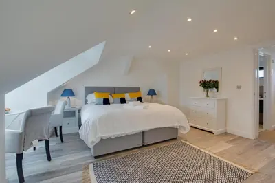 a bedroom with a bed and a desk and a chair at 4 Bed in Padstow oc-p00718 in Padstow