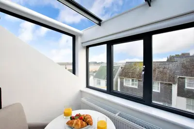 a plate of fruit on a table in a room with windows at 4 Bed in Padstow oc-p00718 in Padstow