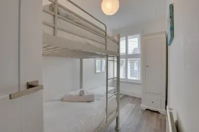 a bedroom with two bunk beds and a window at 4 Bed in Padstow oc-p00718 in Padstow