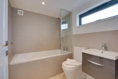 a bathroom with a tub and a toilet and a sink at 4 Bed in Padstow oc-p00718 in Padstow