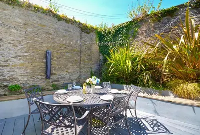 a table and chairs sitting on a patio at 4 Bed in Padstow oc-p00718 in Padstow