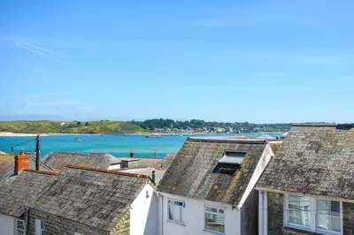 a group of houses with the ocean in the background at 4 Bed in Padstow oc-p00718 in Padstow