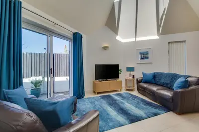 a living room with a couch and a tv at 3 Bed in Trevone oc-p00723 in Padstow