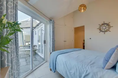a bedroom with a bed and a large window at 3 Bed in Trevone oc-p00723 in Padstow