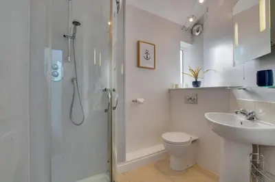 a bathroom with a shower and a toilet and a sink at 3 Bed in Trevone oc-p00723 in Padstow