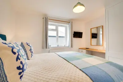 a bedroom with a large bed with a window at 3 Bed in St. Merryn oc-p00725 in St Merryn