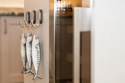 a group of utensils hanging on a kitchen door at 3 Bed in St. Merryn oc-p00725 in St Merryn
