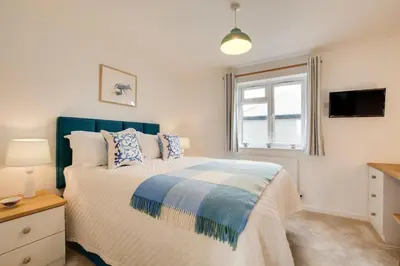 a bedroom with a bed and a window at 3 Bed in St. Merryn oc-p00725 in St Merryn