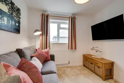 a living room with a couch and a flat screen tv at 3 Bed in St. Merryn oc-p00725 in St Merryn