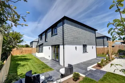 a black and white house with a courtyard at 3 Bed in St. Merryn oc-p00725 in St Merryn