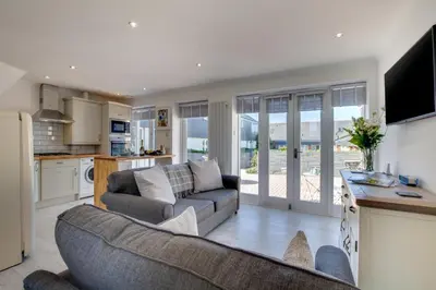 a living room with a couch and a kitchen at 1 Bed in Padstow oc-p00730 in Padstow