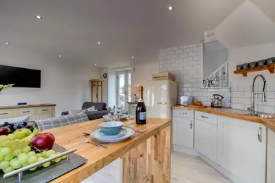 a kitchen with a table with a bowl of fruit on it at 1 Bed in Padstow oc-p00730 in Padstow