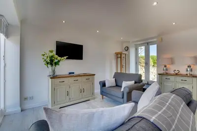 a living room with a couch and a tv at 1 Bed in Padstow oc-p00730 in Padstow