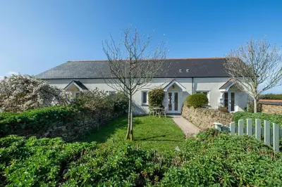 a white house with a fence in front of it at 1 Bed in Padstow oc-p00730 in Padstow