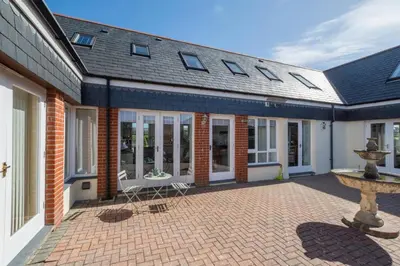 a house with a brick courtyard with a fountain at 1 Bed in Padstow oc-p00730 in Padstow