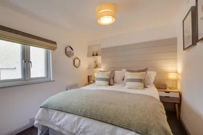 a bedroom with a large bed and a window at 1 Bed in Padstow oc-p00735 in Padstow
