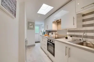 a kitchen with white cabinets and a sink at 1 Bed in Padstow oc-p00735 in Padstow