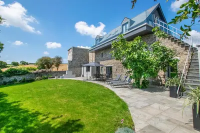 an exterior view of a house with a lawn at 5 Bed in Little Petherick oc-p00736 in Little Petherick