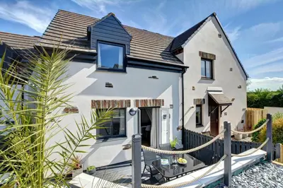 a white house with a black roof at 3 Bed in Padstow oc-p00742 in Padstow