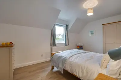 a bedroom with a large bed and a window at 3 Bed in Padstow oc-p00742 in Padstow