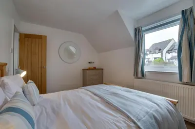 a bedroom with a large bed and a window at 3 Bed in Padstow oc-p00742 in Padstow