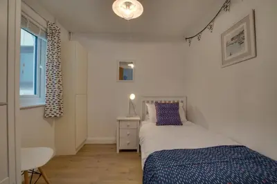 a small bedroom with a bed and a window at 3 Bed in Padstow oc-p00742 in Padstow
