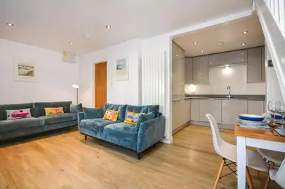 a living room with two couches and a kitchen at 3 Bed in Padstow oc-p00742 in Padstow