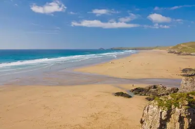 a beach with people walking on the sand and the ocean at 1 Bed in Mitchell oc-p00750 in Mitchell