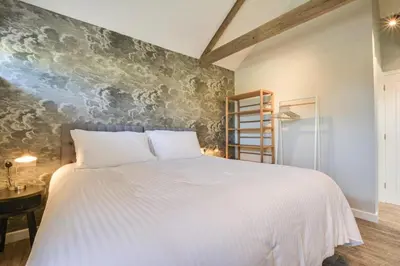 a bedroom with a white bed and a wall at 1 Bed in Mitchell oc-p00750 in Mitchell