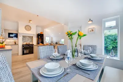 a dining room and kitchen with a table and chairs at 3 Bed in Trevone oc-p00758 in St Merryn
