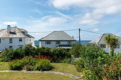 two white houses with the ocean in the background at 3 Bed in Trevone oc-p00758 in St Merryn