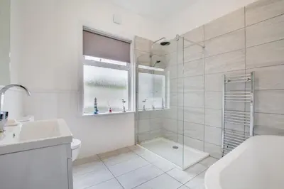 a bathroom with a shower and a toilet and a sink at 3 Bed in Trevone oc-p00758 in St Merryn