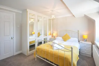 a bedroom with a bed and a sink and a mirror at 4 Bed in Padstow oc-p00759 in Padstow